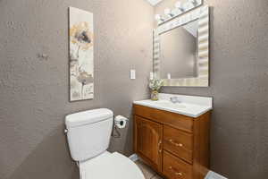 Bathroom featuring vanity and a textured wall
