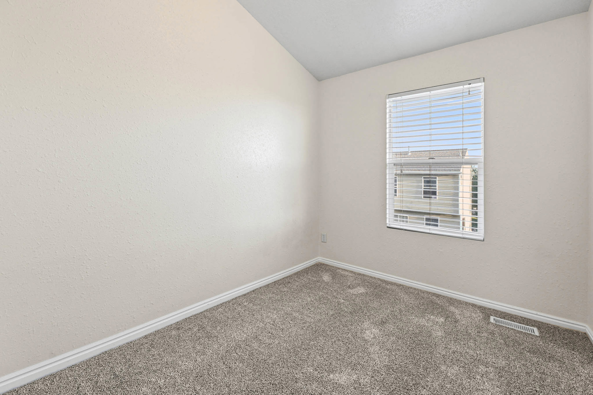 Bedroom #2 with vaulted ceiling, two toned paint and newer carpet