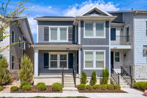 View of front facade featuring board and batten siding and a balcony