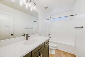Full bath with vanity, shower / bath combination, and light tile patterned flooring
