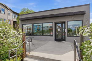 Doorway to property featuring stucco siding