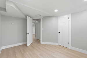 Unfurnished bedroom with light wood finished floors and recessed lighting