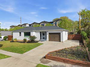 View of front of house with driveway and an attached garage