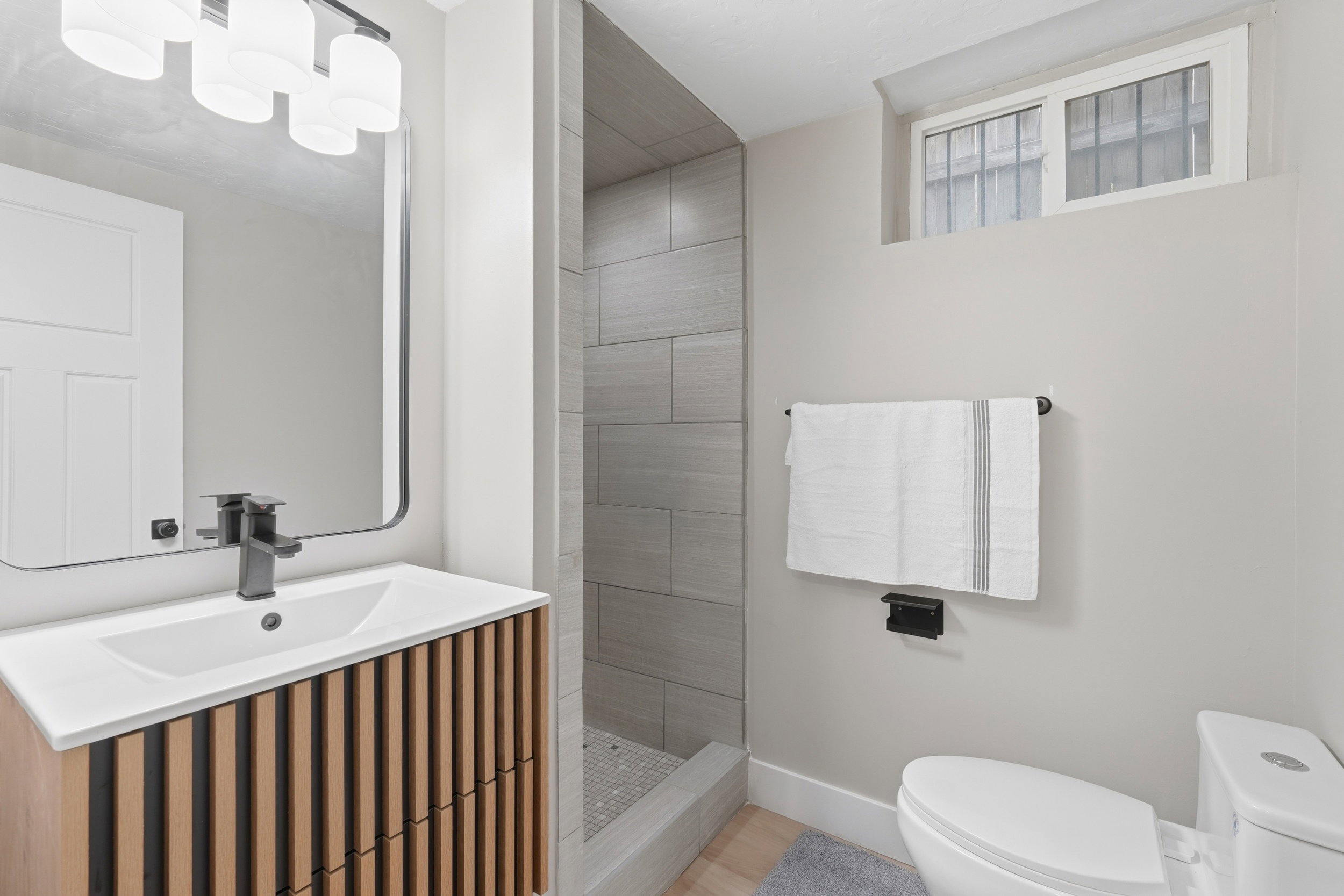 Full bathroom featuring a walk in shower and vanity