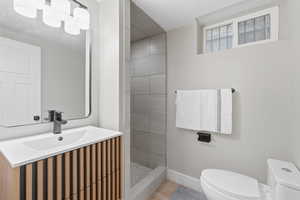 Full bathroom featuring a walk in shower and vanity