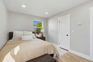 Bedroom with light wood-style floors and recessed lighting