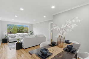 Exercise area featuring light wood-style flooring, recessed lighting, and ornamental molding
