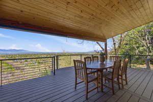 Deck featuring outdoor dining area and a mountain view