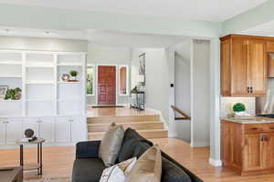 Living room featuring baseboards and light wood-type flooring