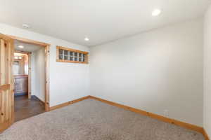 Spare room featuring carpet flooring and recessed lighting