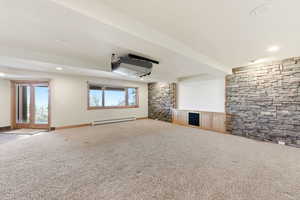 Unfurnished living room featuring carpet, recessed lighting, and baseboard heating