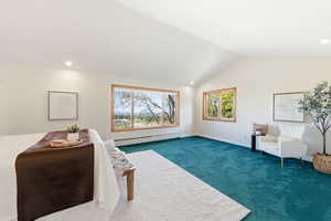 Sitting room with dark carpet, a baseboard radiator, recessed lighting, plenty of natural light, and vaulted ceiling