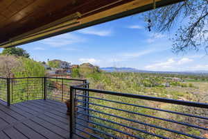 Wooden deck with a residential view and a mountain view