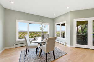 Dining room with baseboard heating, healthy amount of natural light, light wood-style floors, and recessed lighting