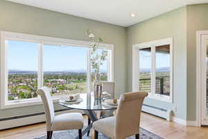 Dining space featuring a baseboard heating unit, light wood-style flooring, and recessed lighting