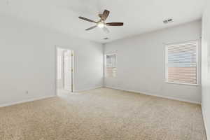 Unfurnished room featuring light carpet and a ceiling fan