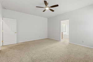 Empty room with light carpet and a ceiling fan