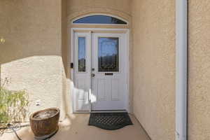 Property entrance with stucco siding