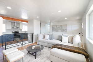 Living area featuring light wood-type flooring and recessed lighting
