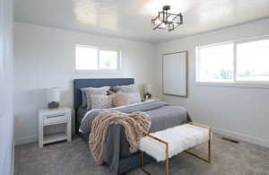 Bedroom featuring carpet and baseboards