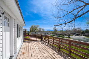 Wooden terrace featuring a residential view