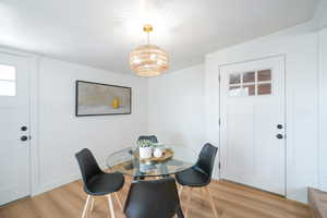 Dining area with wood finished floors and suspended lighting