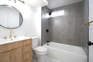 Full bath featuring vanity, shower / tub combination, and marble finish floors