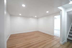 Finished basement with recessed lighting and light wood finished floors