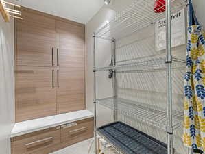 Rare mudroom at entry complete with boot warmers and custom cabinetry