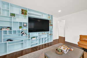 Living room featuring dark wood-style floors and recessed lighting