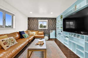 Living room with dark wood-style floors and recessed lighting