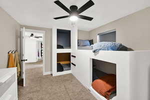 Bedroom featuring light colored carpet and a ceiling fan