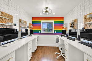 Office with built in study area, dark wood-type flooring, and recessed lighting