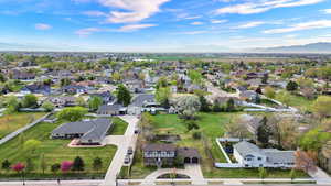 Aerial perspective of suburban area with a mountainous background