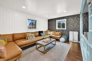 Living room featuring dark wood finished floors and recessed lighting