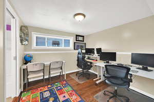 Daylight office space, Bedroom #4 or guest suite featuring dark wood-style flooring,