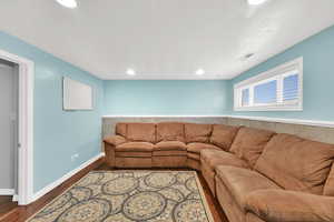 Living area featuring wood finished floors and recessed lighting