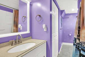Full bath with vanity and curtained shower