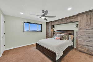 Bedroom with light colored carpet, a ceiling fan, and recessed lighting
