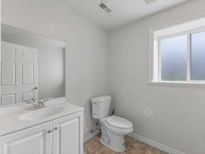 Bathroom featuring vanity, a textured ceiling, and light tile patterned floors