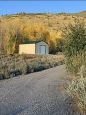 View of outdoor structure featuring driveway