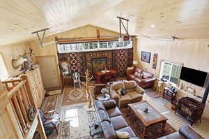 Living room featuring wooden ceiling and wooden walls