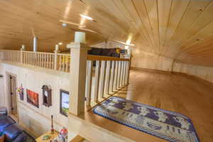 Corridor featuring hardwood / wood-style floors and wooden ceiling