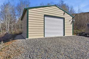 Detached garage featuring gravel driveway