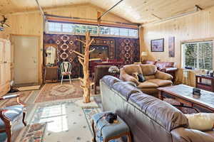 Living area with plenty of natural light and wood ceiling