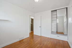 Bedroom 3 with light wood-type flooring and baseboards