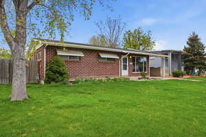 Ranch-style house with brick siding