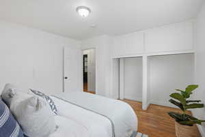 Primary Bedroom with wood finished floors and baseboards