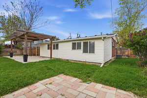 Back of house featuring a patio area, a pergola, and a fenced backyard