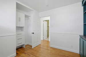 Bedroom 2 featuring light wood-style flooring and baseboards
